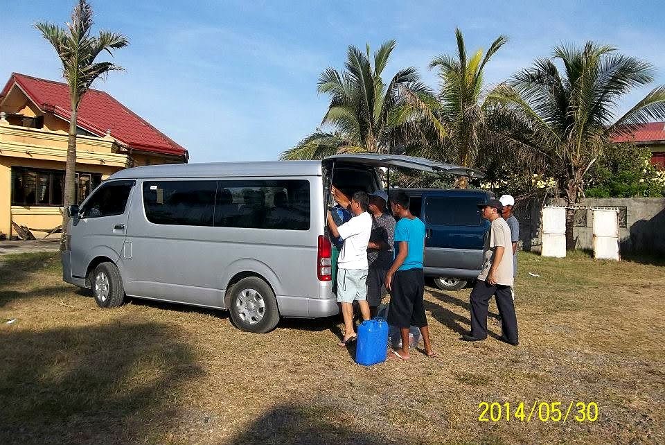 Packing up the vehicles to go to Claveria to ride a fishing boat to Fuga Island